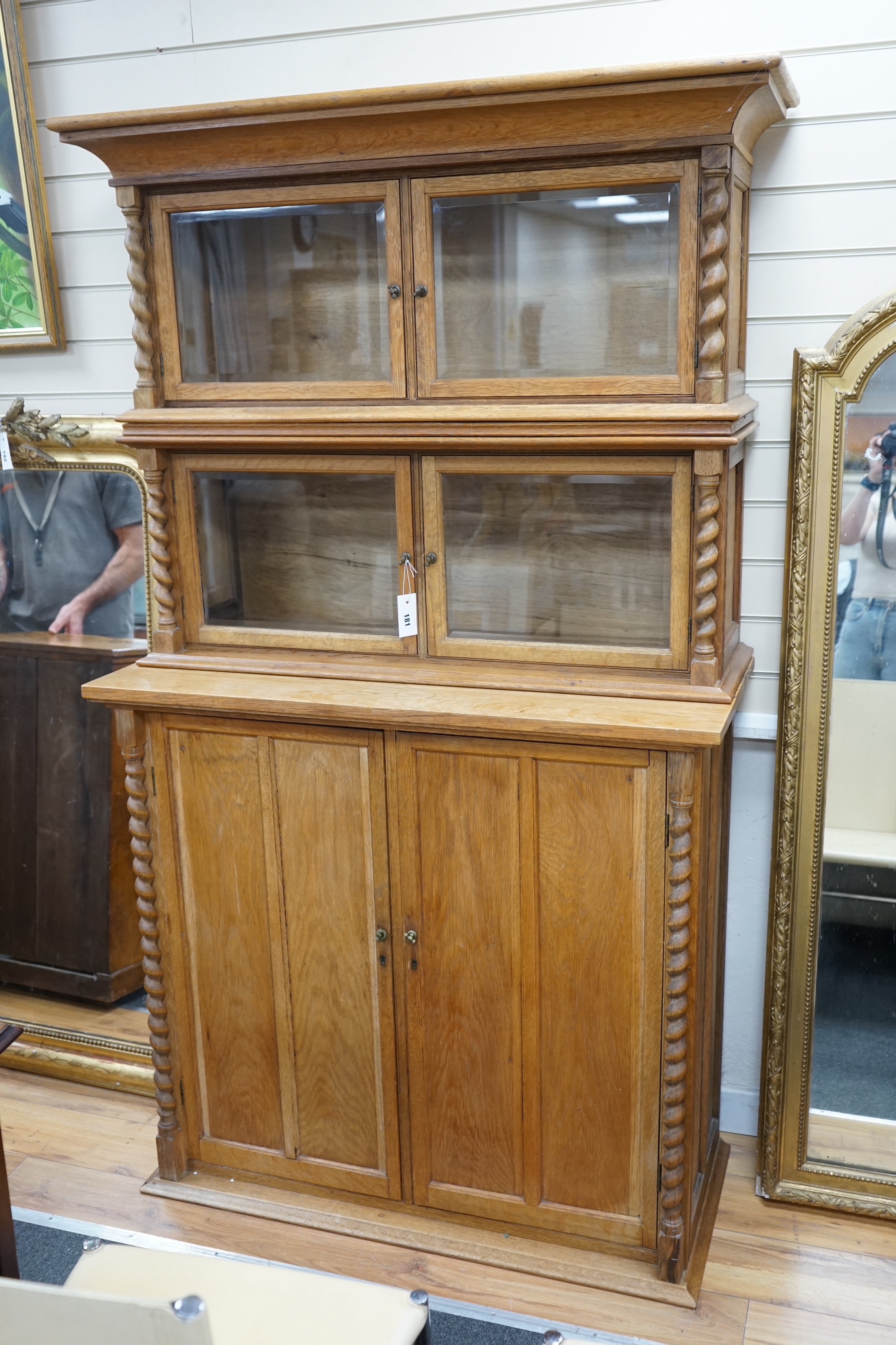 An early 20th century oak three part side cabinet, width 105cm, depth 47cm, height 188cm